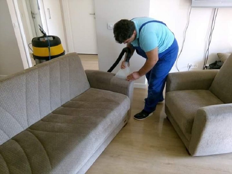 Ofiste gri kanepenin vakumla yıkanması